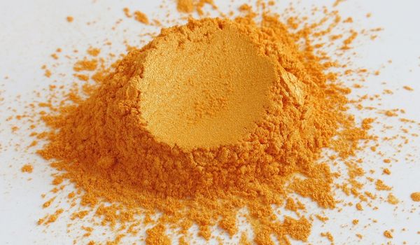 A mound of orange Coenzyme q10 powder